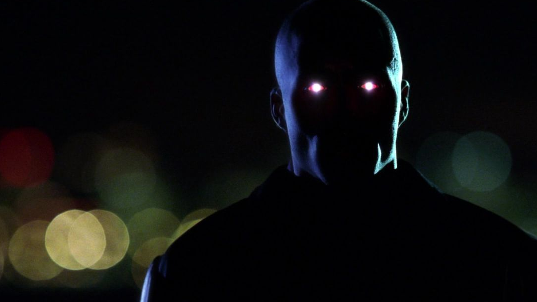 A shadowy figure with glowing red eyes.