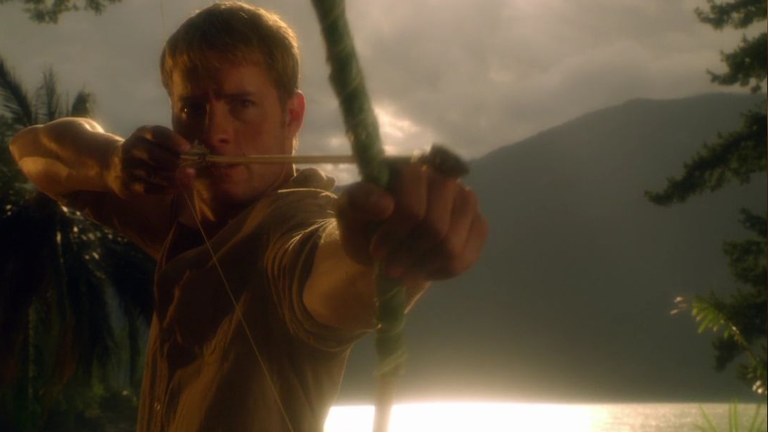 An archer holds a bow on a desert island.