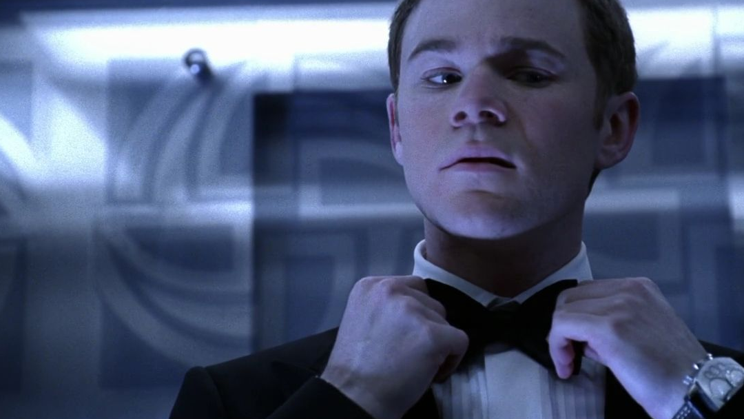 A man adjusting his bowtie.