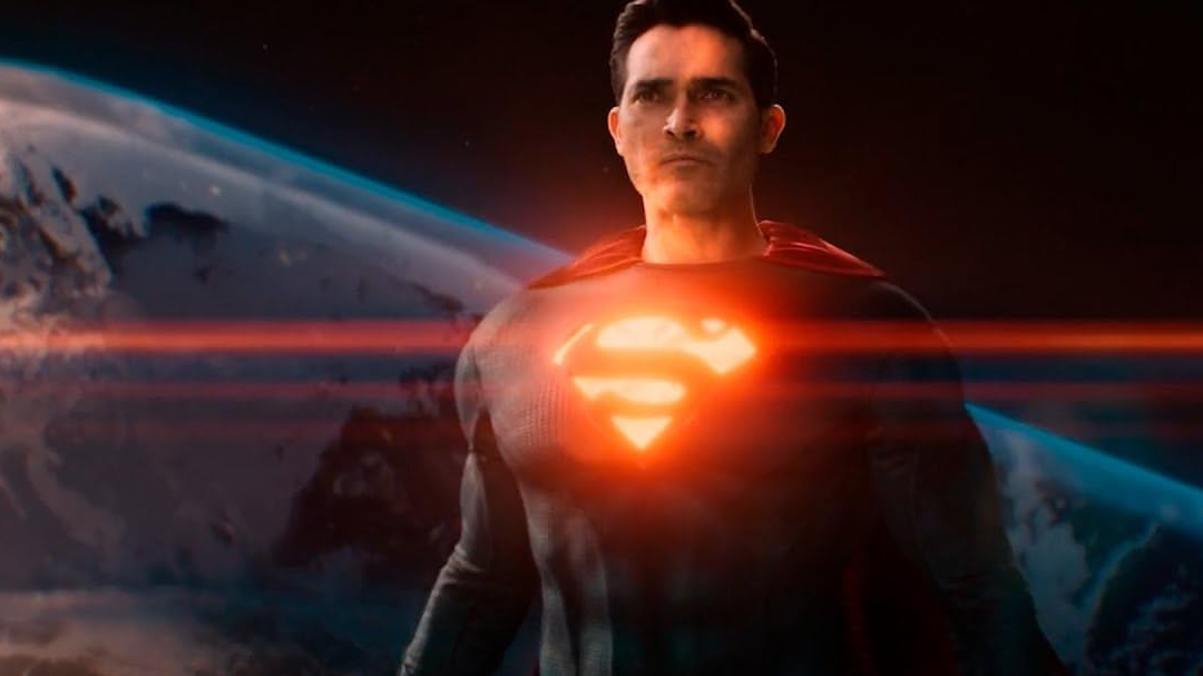 superman hovering in space, the crest on his chest glowing.
