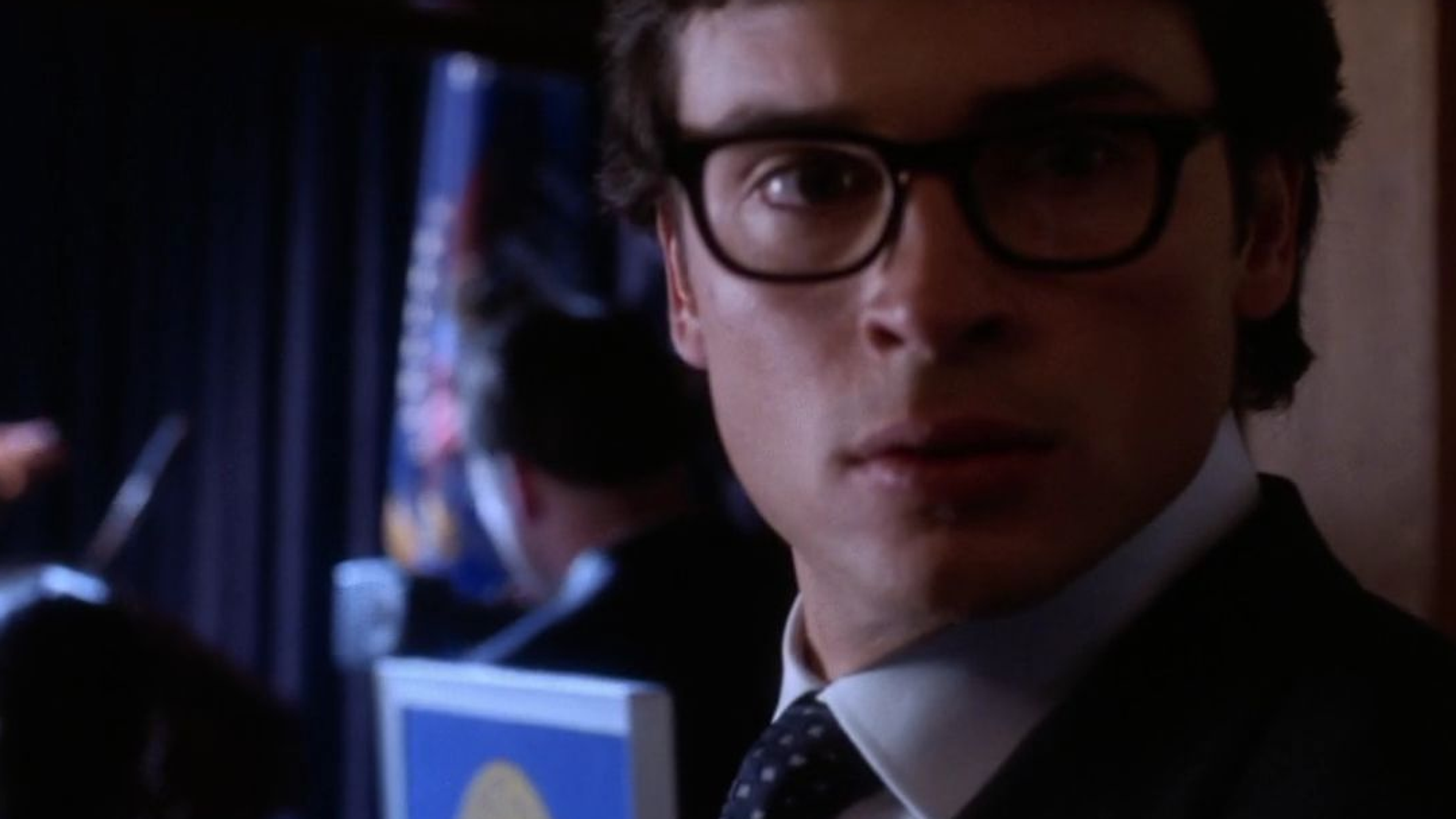 A man in a suit and glasses.