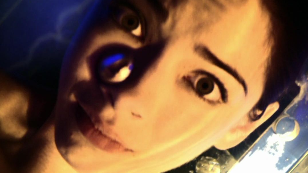 a panicked looking woman is undergoing some sort of experiment.