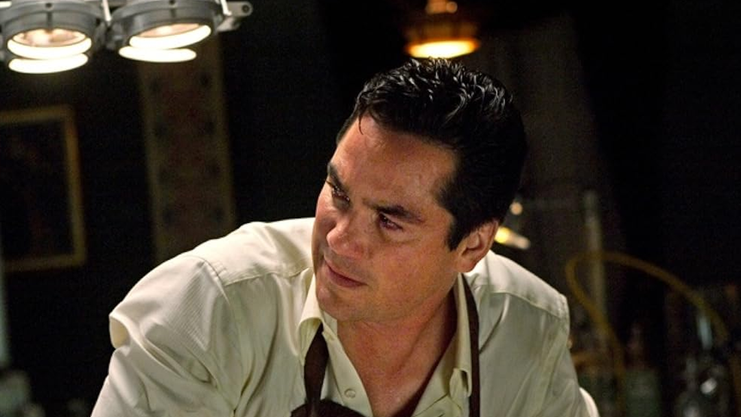 A man in an apron looks distraught.