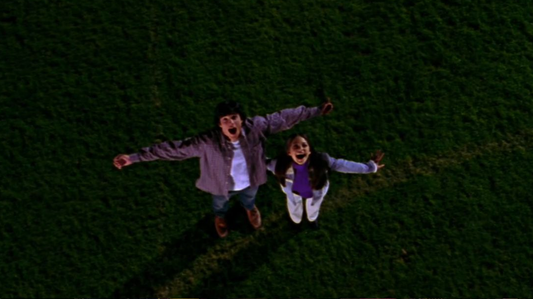 Clark and Lana screaming on the football field.