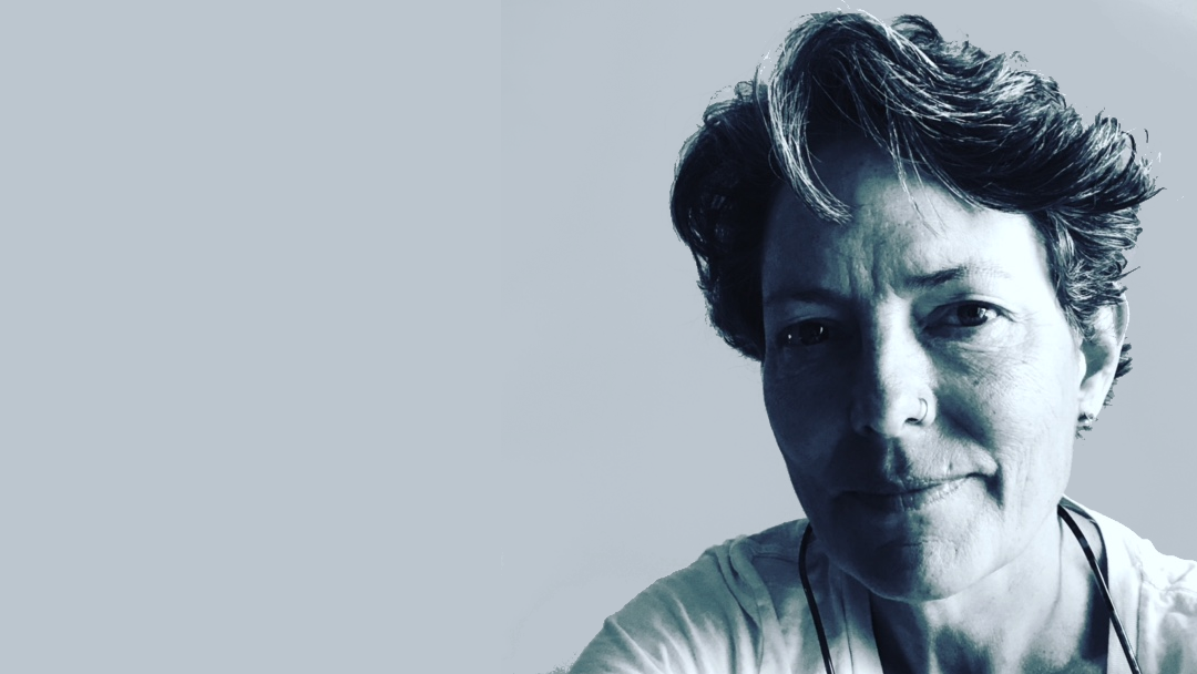 A black and white photo of a short haired woman.