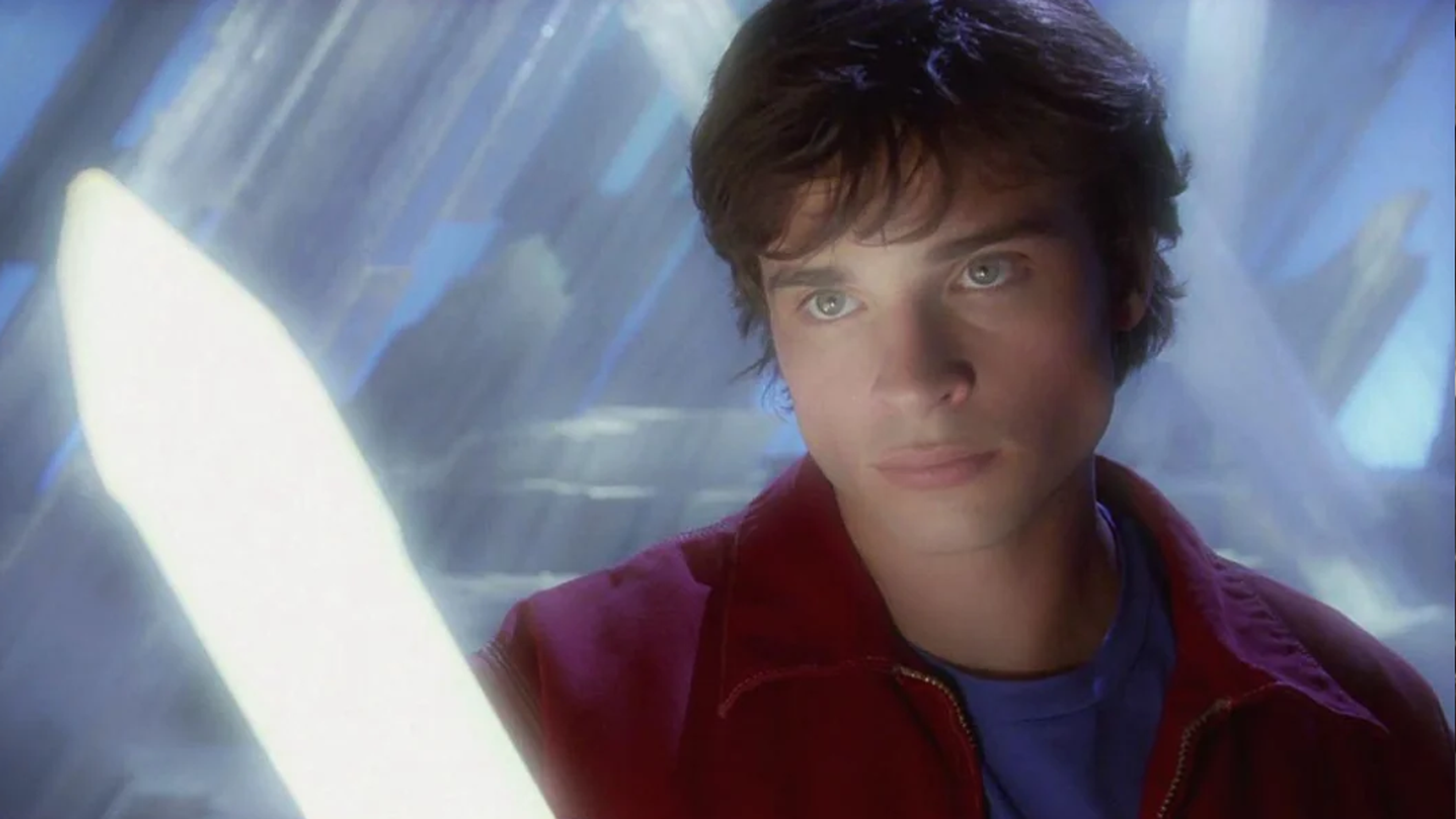 A young man holding a glowing crystal.