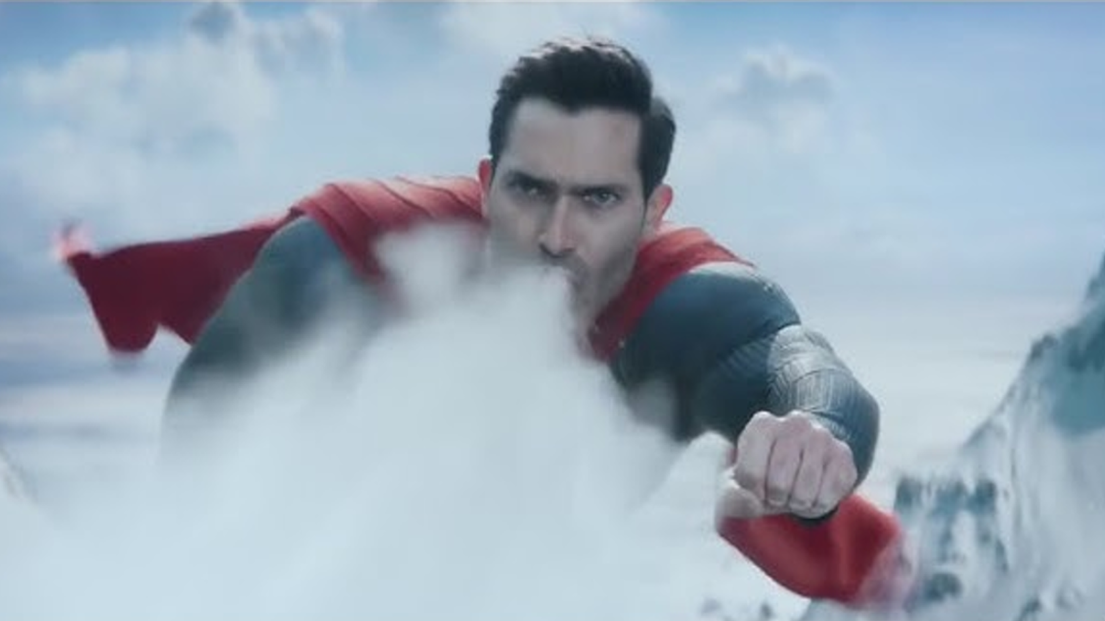 Superman using his super breath to stop an avalanche.