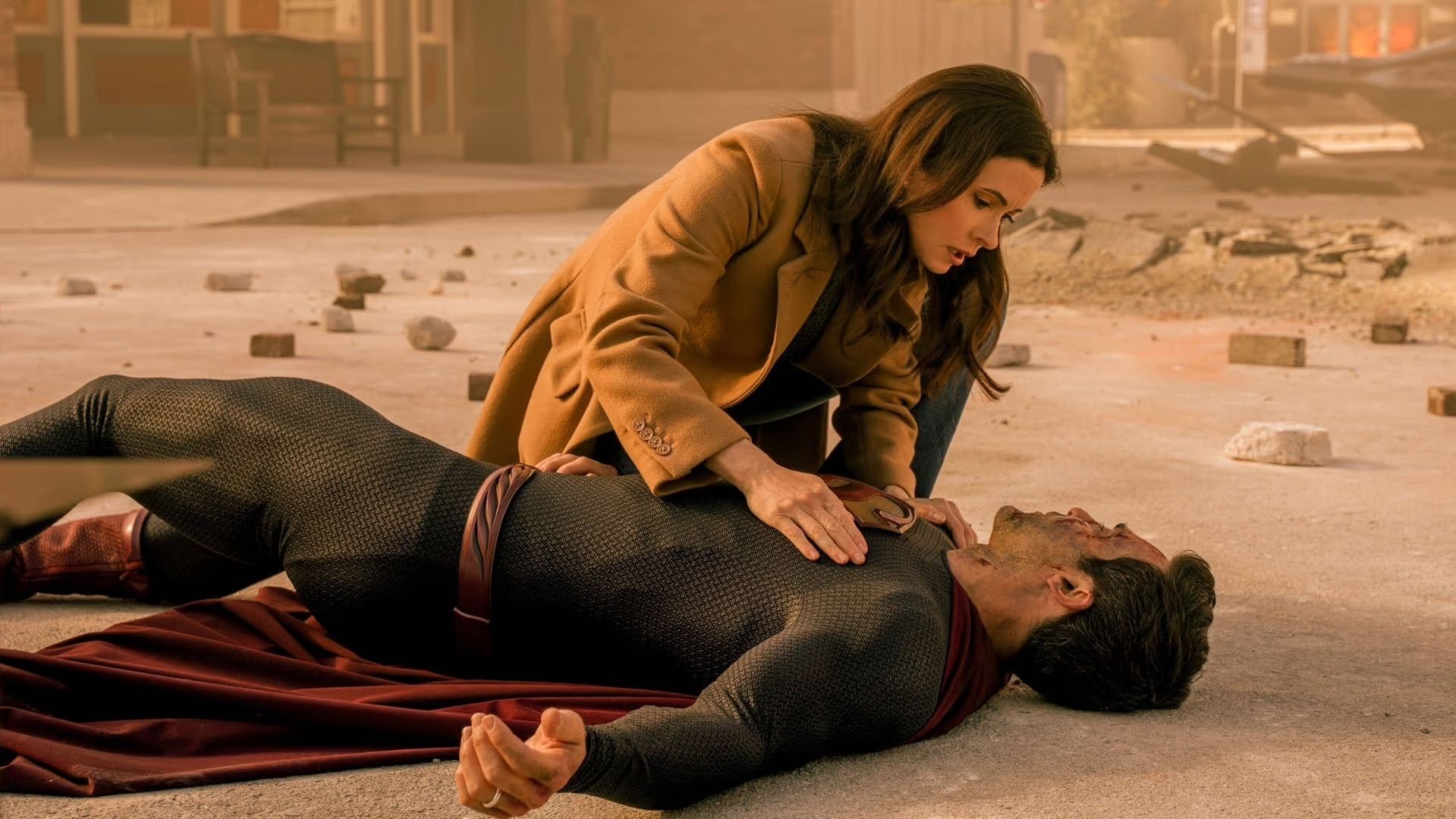 Lois kneels over a beaten Superman during his battle with Domsday in the series finale of The CW's "Superman and Lois"