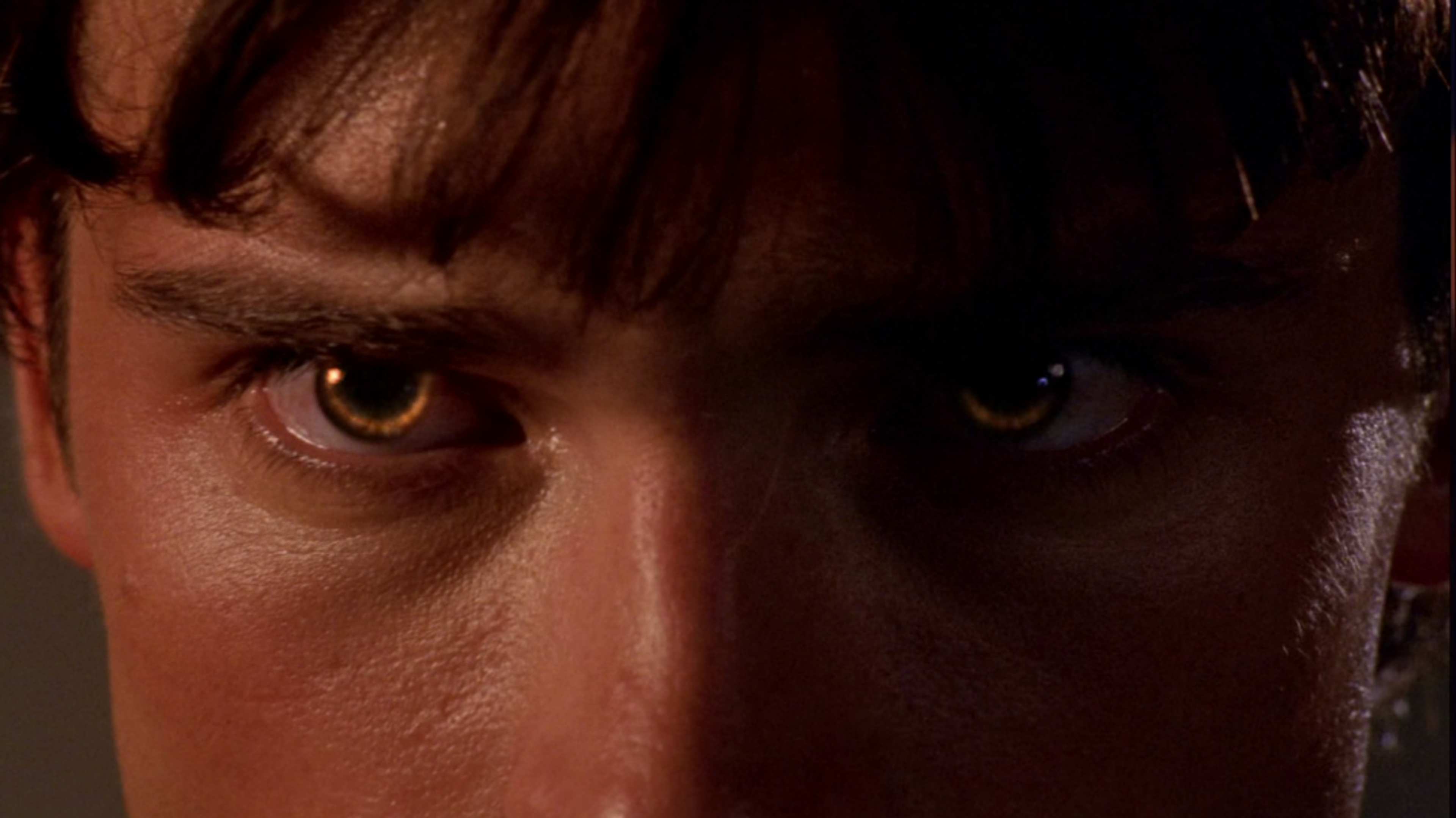 a close up of clark kent's eyes as he uses heat vision.