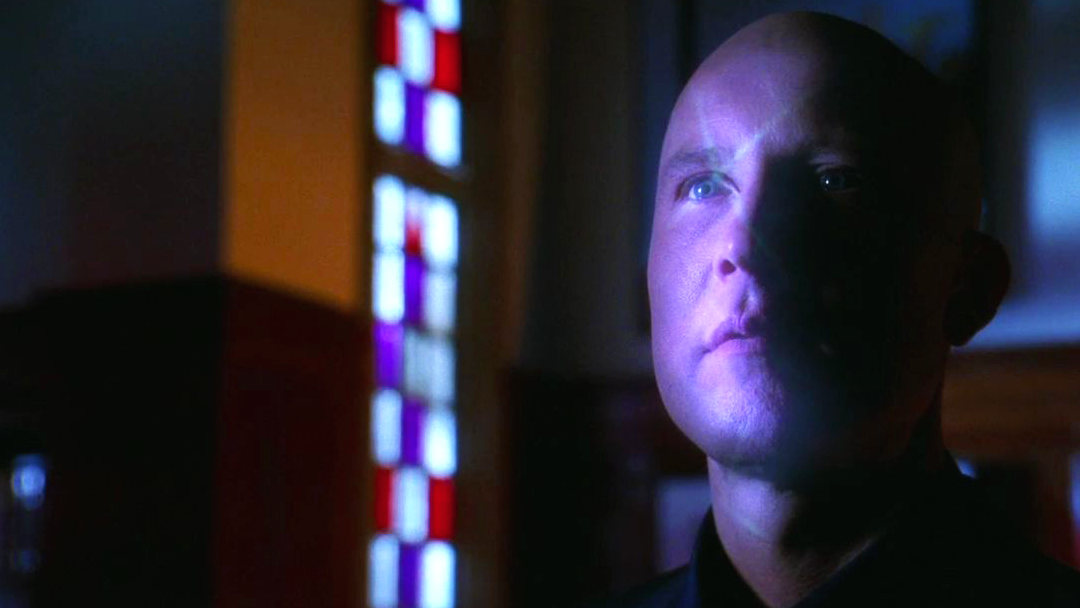 A holographic map is projected onto Lex Luthor's face.