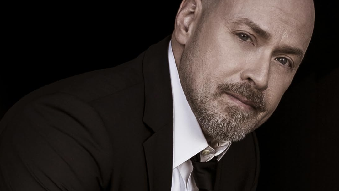 A bald man with a beard.