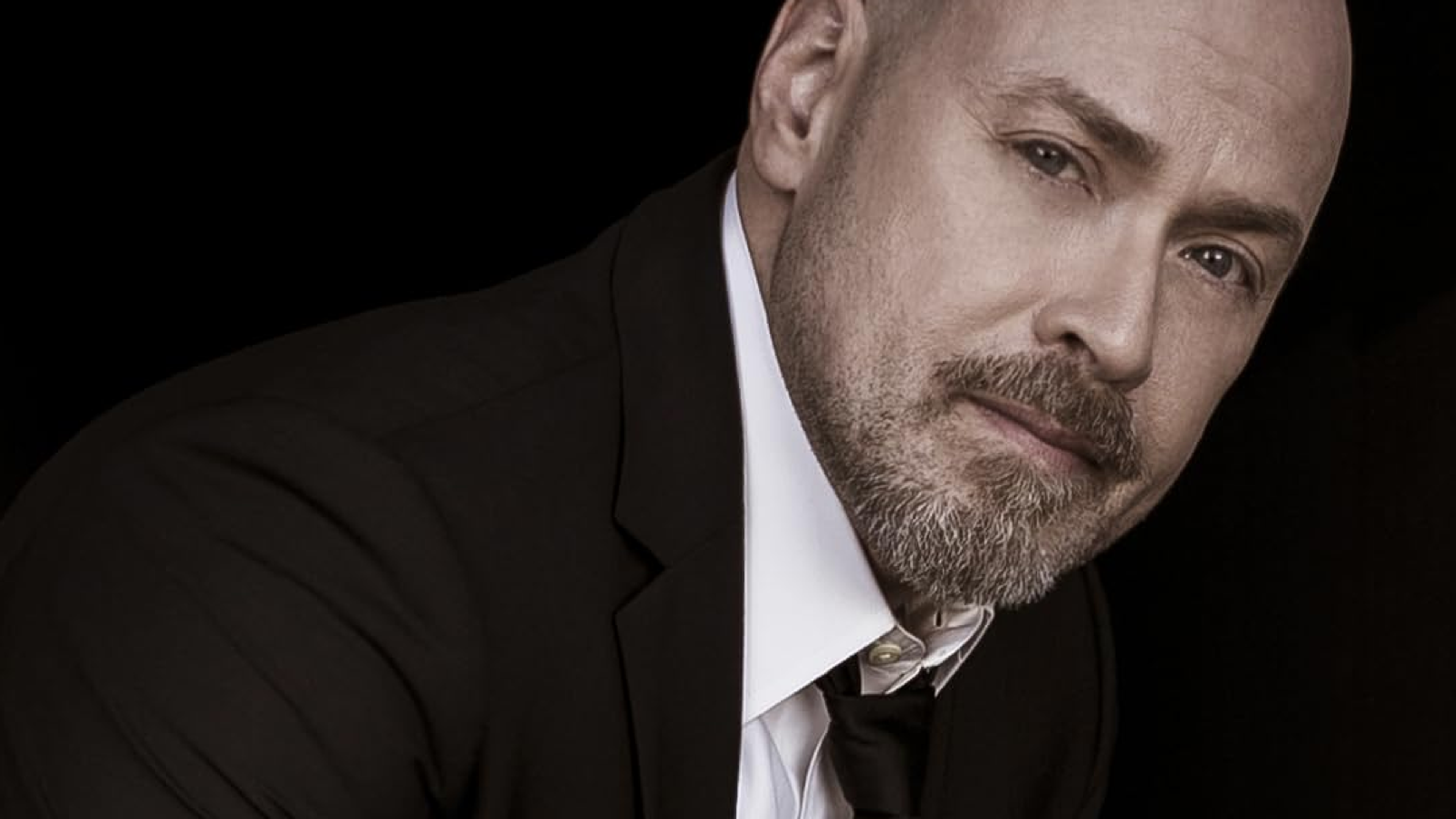 A bald man with a beard.