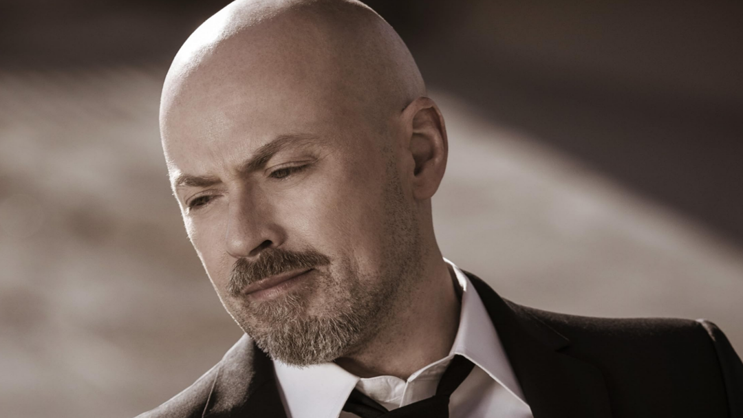 A bald man with a beard.