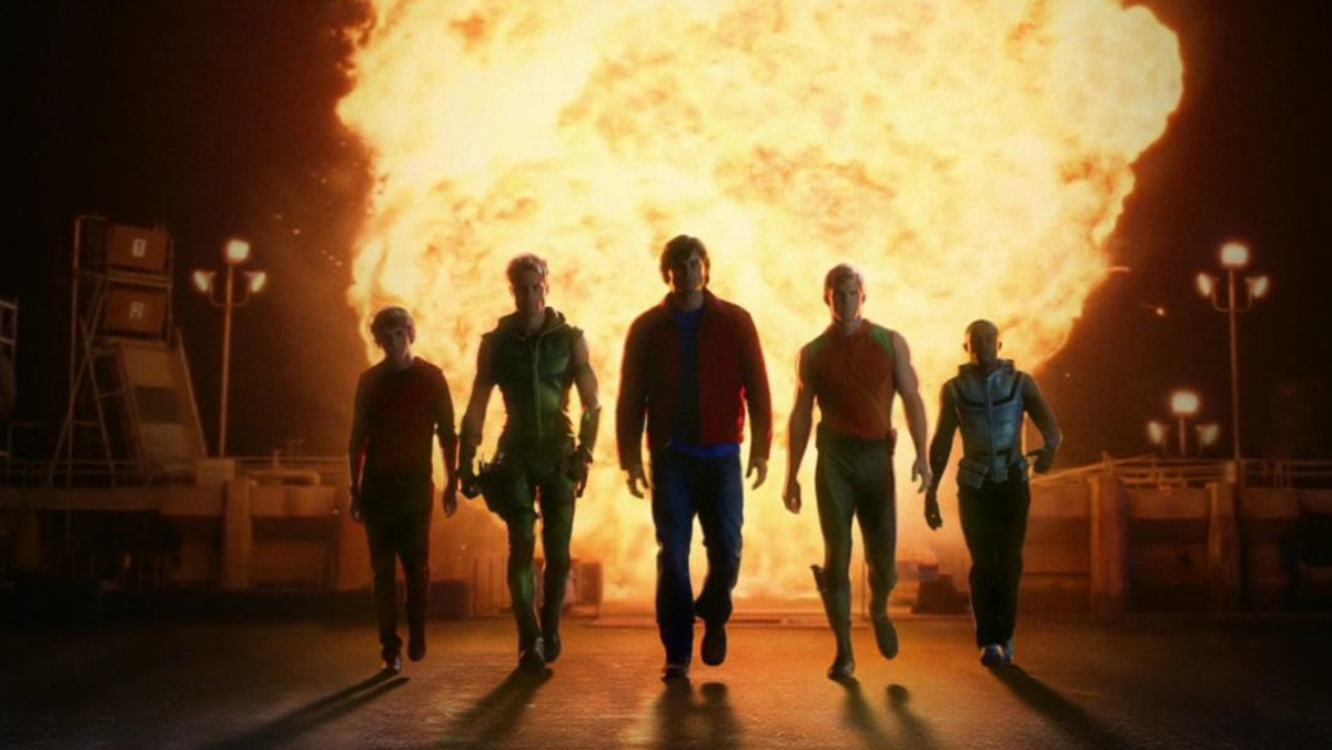 The Justice League walking away from an explosion.