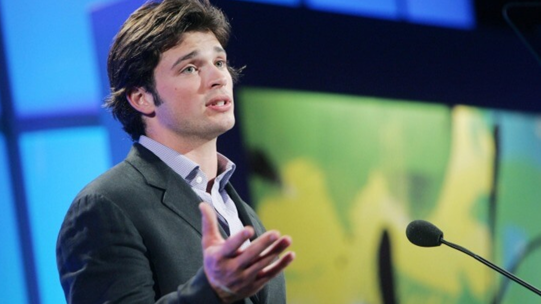 A man in a suit is at a press conference.