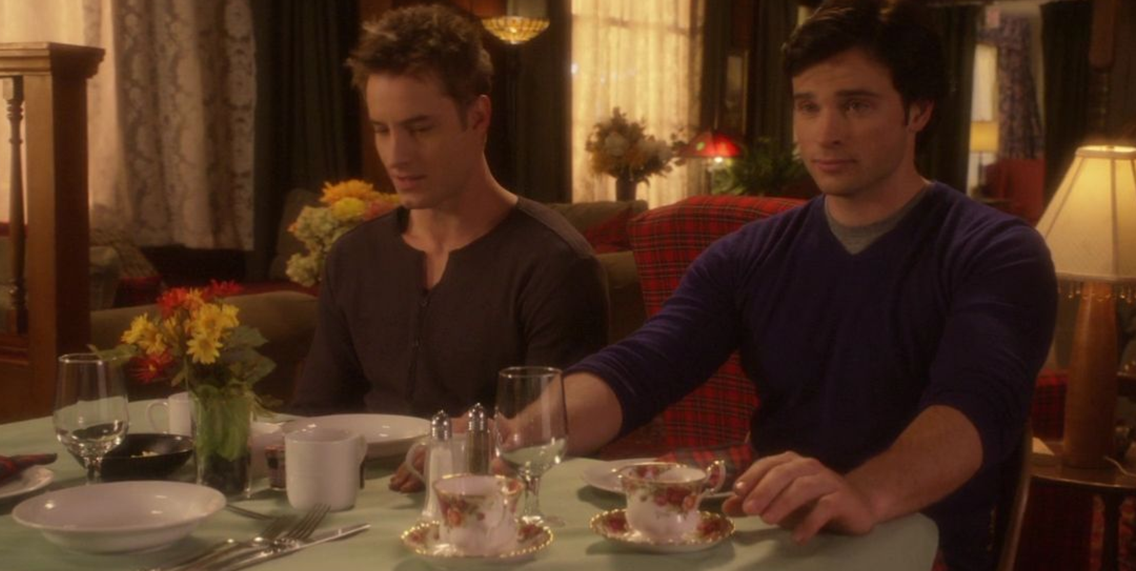 Clark and Oliver awkwardly sitting together at a table.