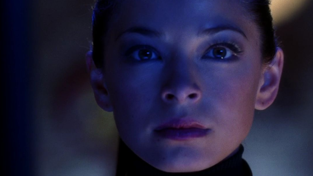 A woman with a stone faced expression.