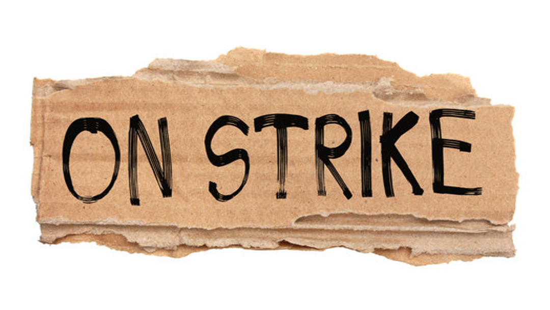 A cardboard strike sign.