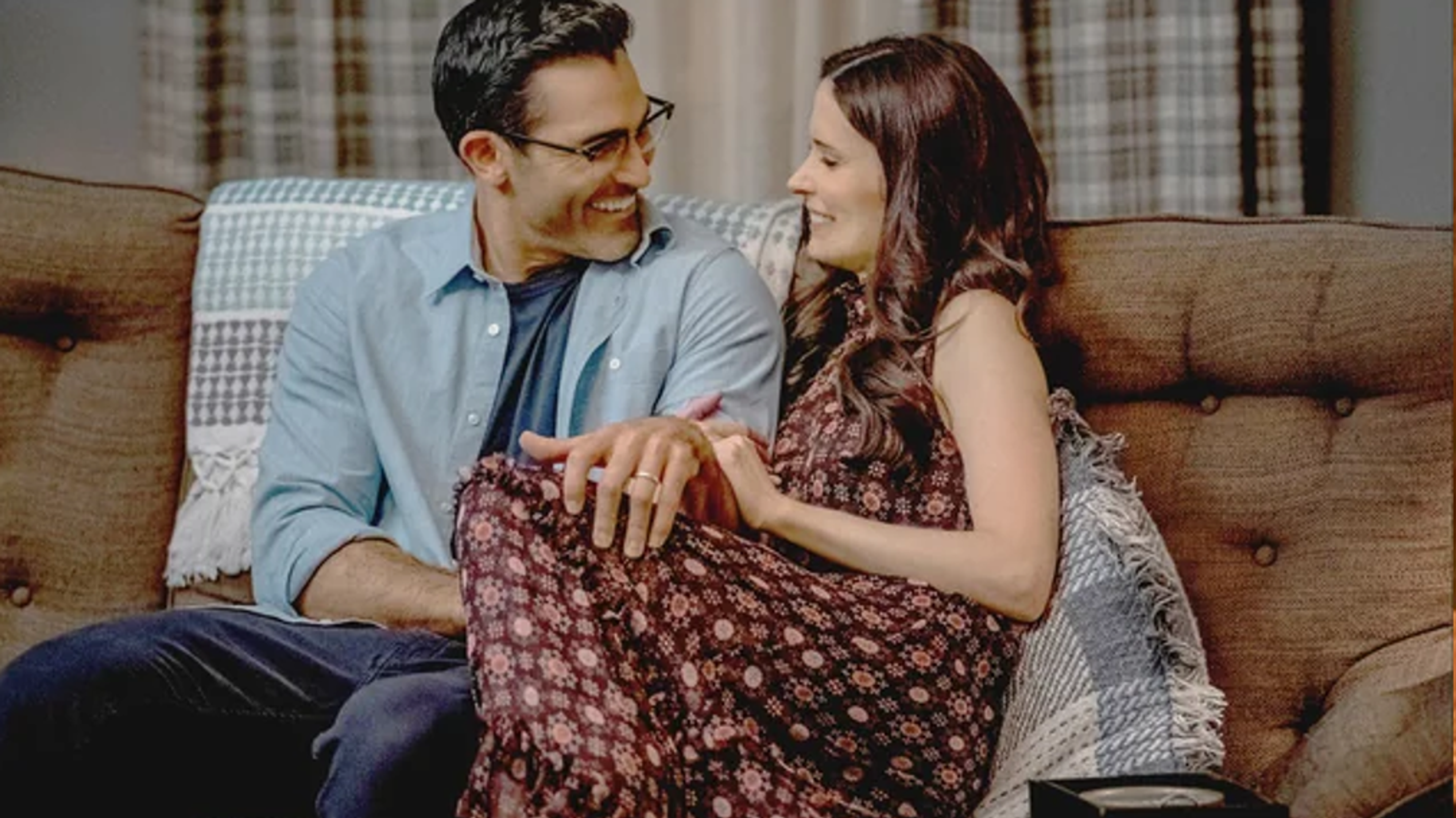clark and lois sitting together on a couch.