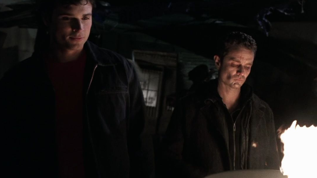 Brainiac and Bizarro over a trashcan fire.