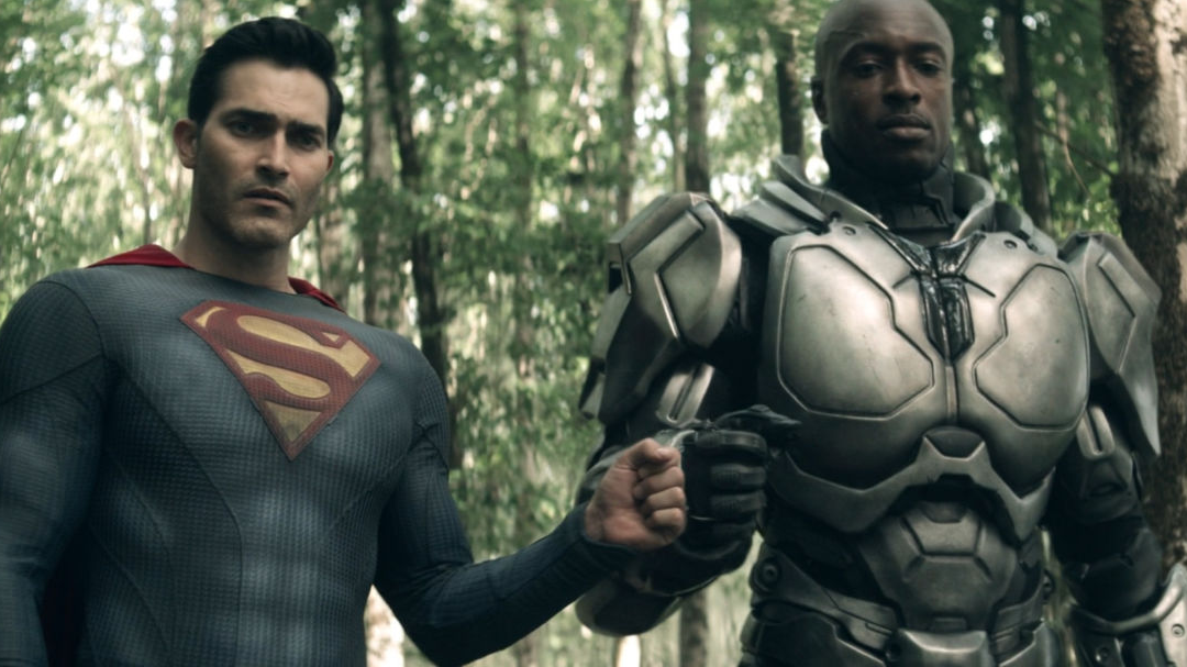 Superman and John Henry bumping fists.