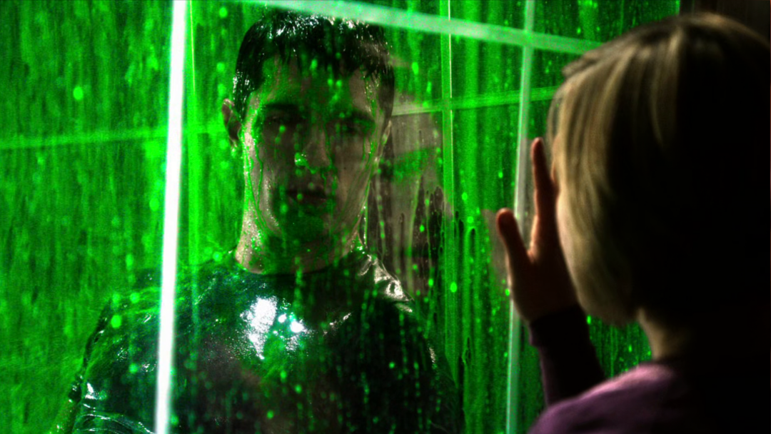 A man in a cage with liquid kryptonite raining down upon him.