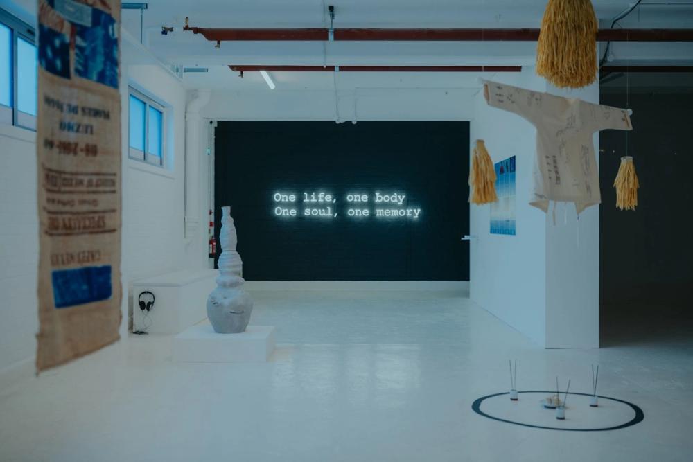 An image from the Karst Exhibition. A screen that says one life, one body, one soul, one memory.