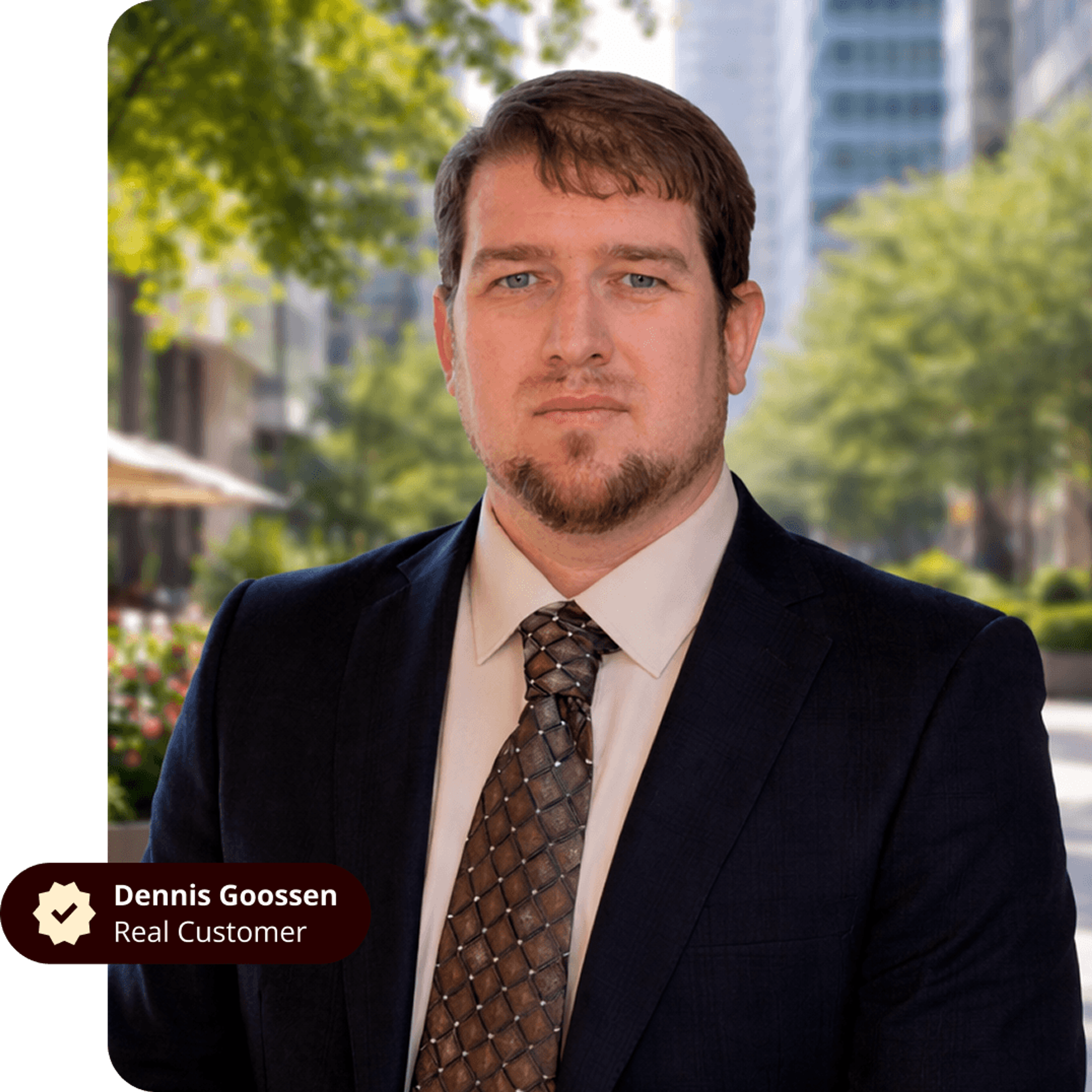 Dennis Goossen, a real customer, wearing a suit and tie, against a blurred urban background.
