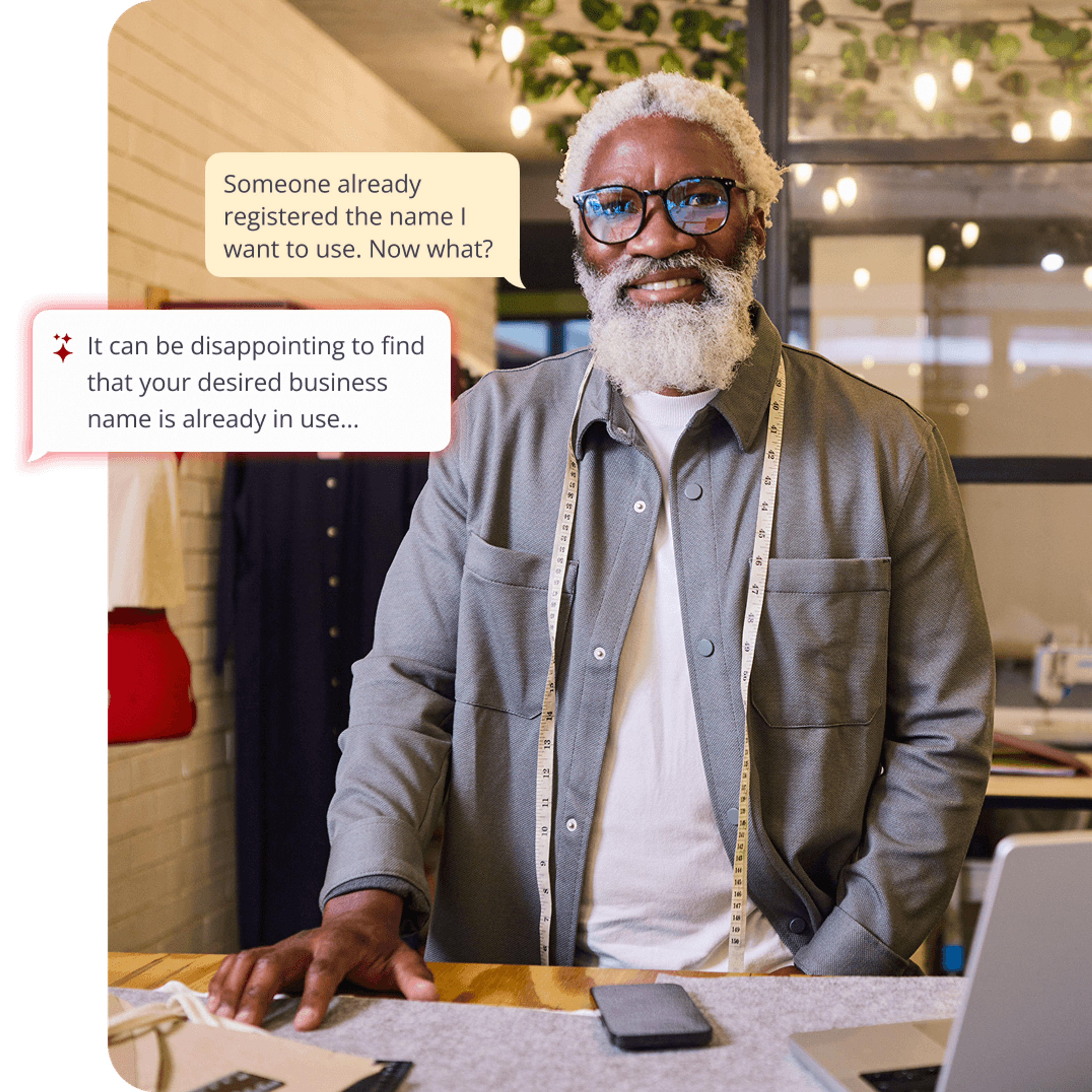 Smiling Black man with a measuring tape around his neck stands at a desk with a laptop, with speech bubbles about his desired business name being taken.
