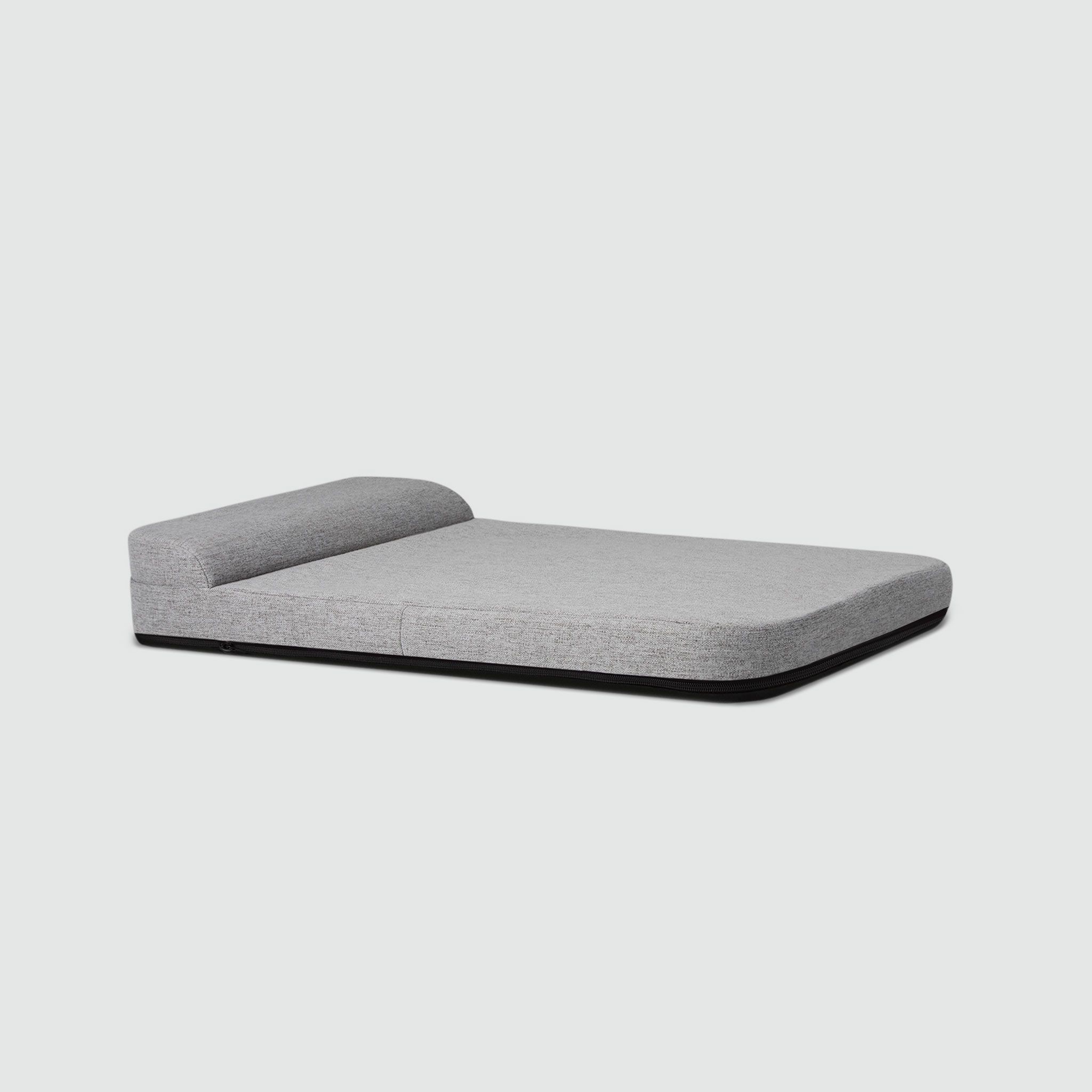 A bolstered dog bed with a grey cover