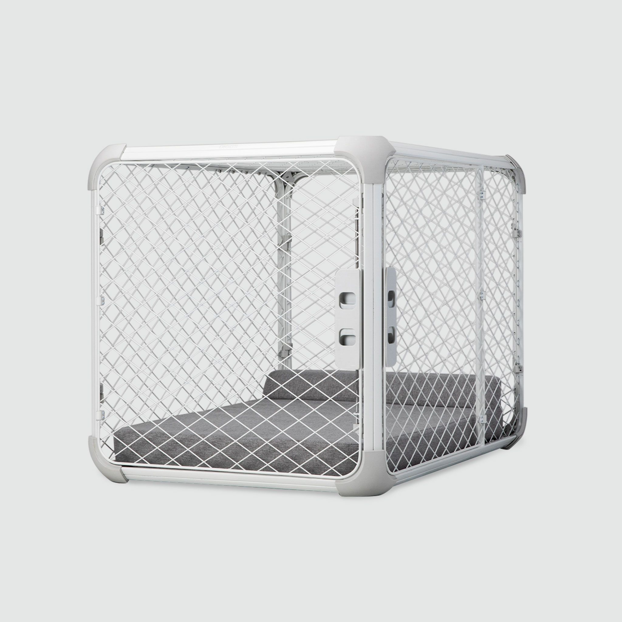 A white metal dog crate with a dog bed inside of it