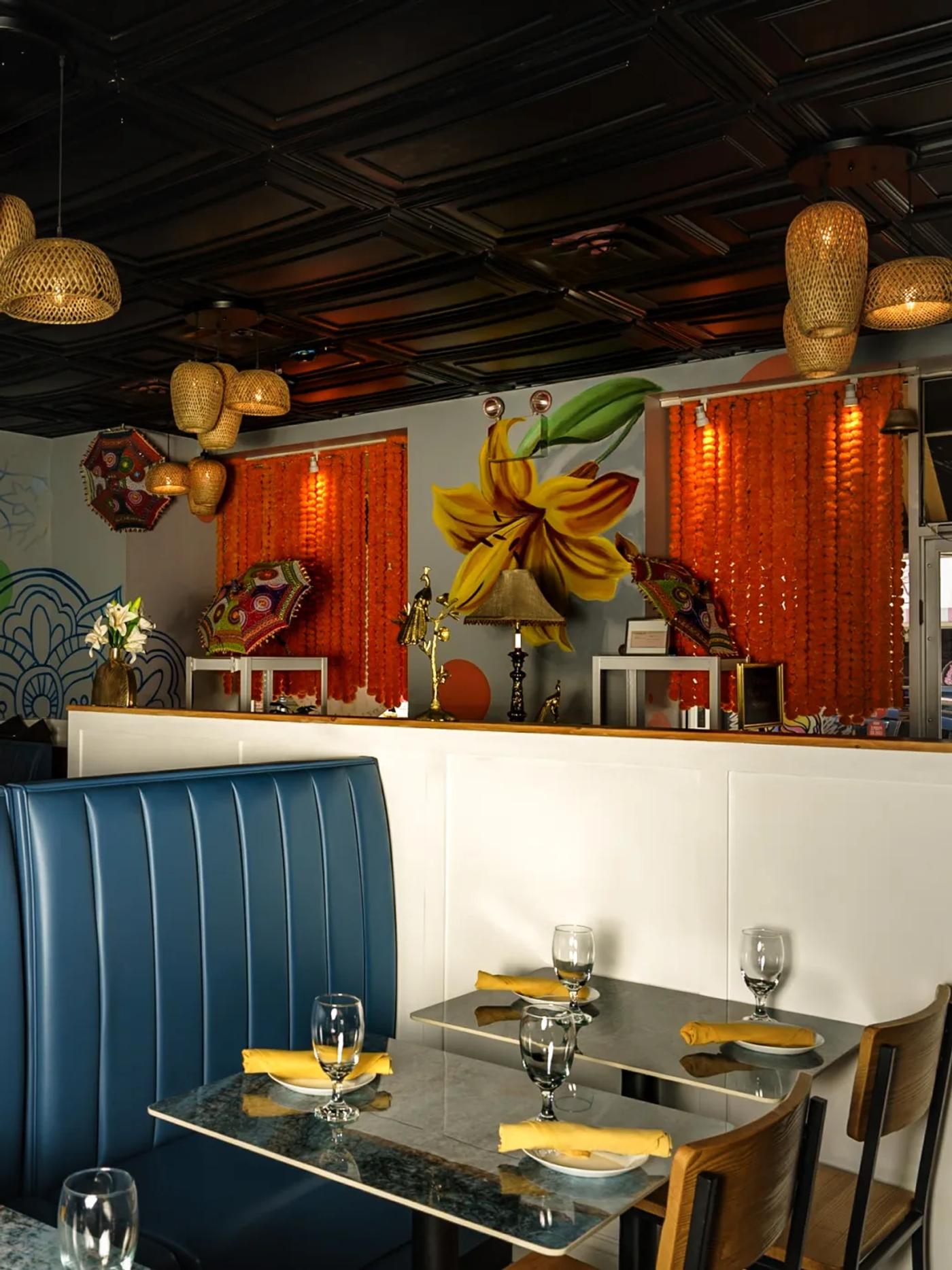 A set table in Lilly's dining room under the marigold garlands and lily mural