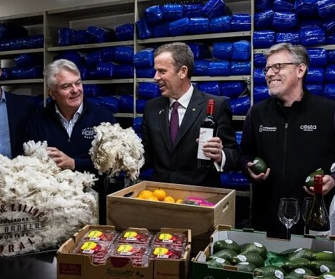 Minister for Trade, Tourism and Investment Dan Tehan (second right) holds wool and a bottle of wine during a press conference about the signing of the trade agreement with India, in Melbourne. (Source: AAP)
