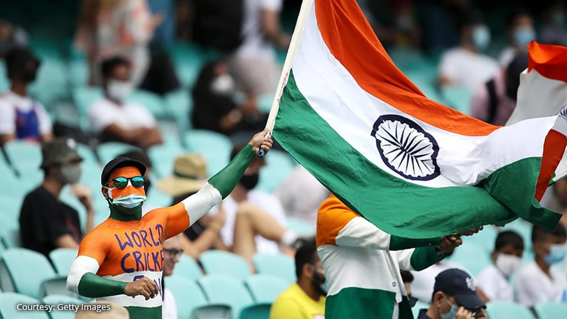 Indian cricket fan body painted with indian flag and waving Indian flag