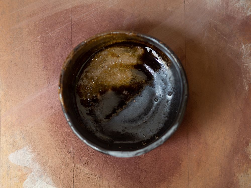 Inside black teabowl with runny glaze