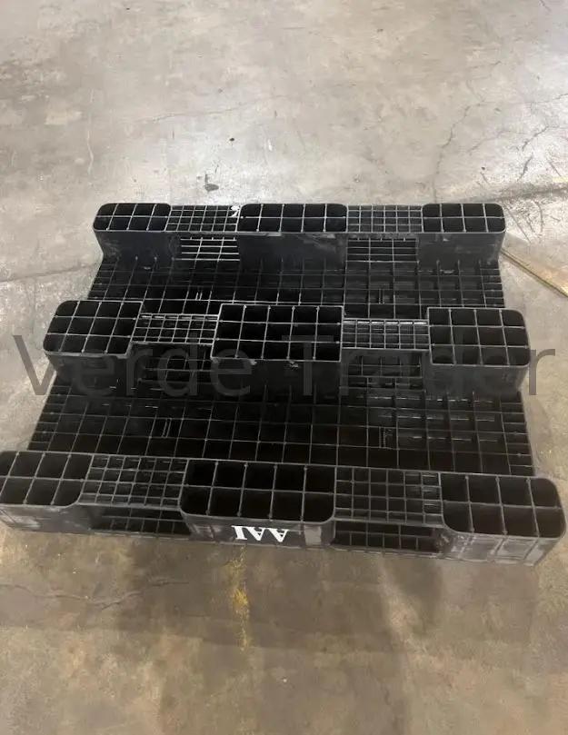Underside of a plastic pallet showing molded runners and structural ribs