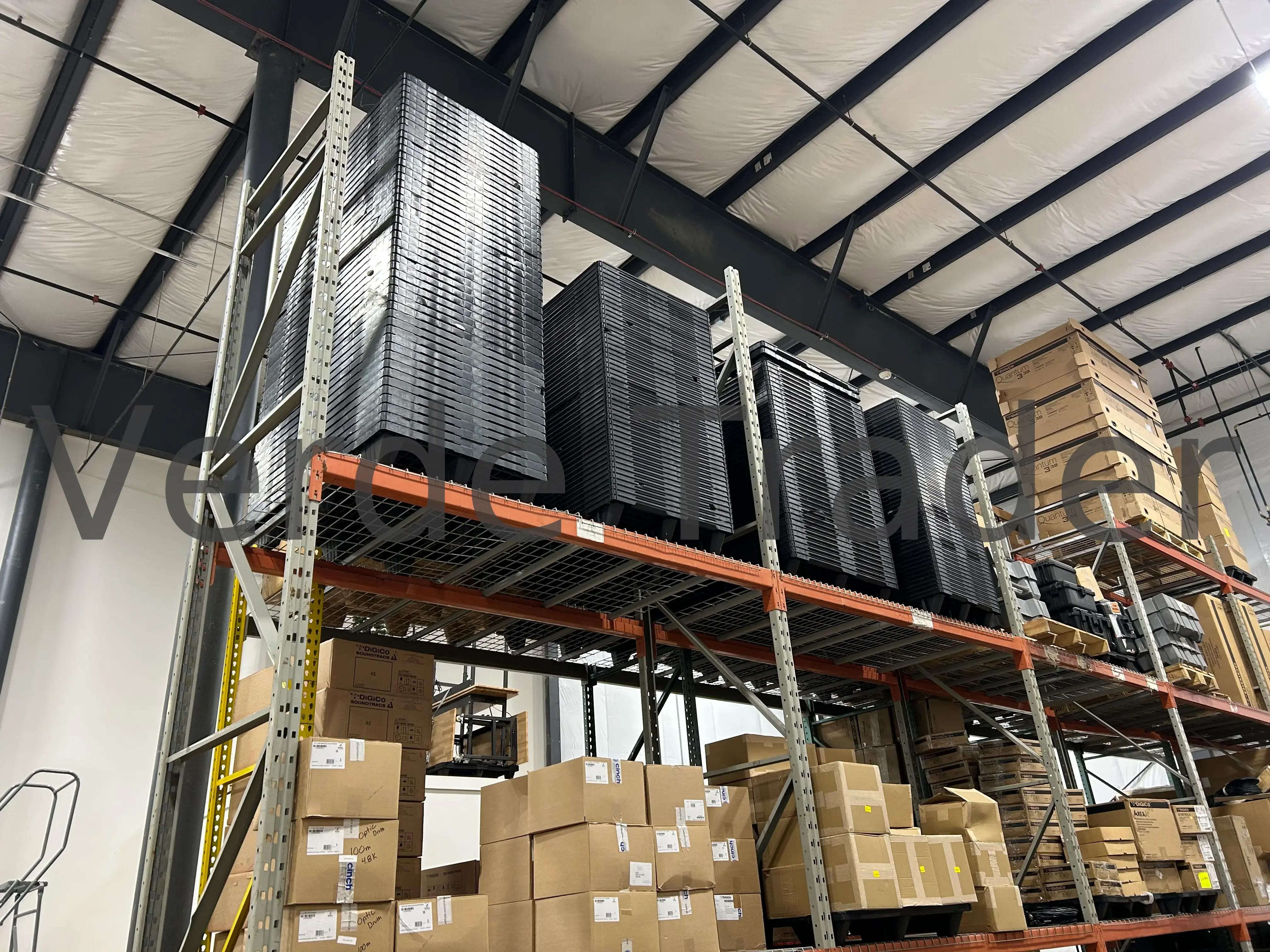 Rackable plastic pallets stored on warehouse beam rack shelving