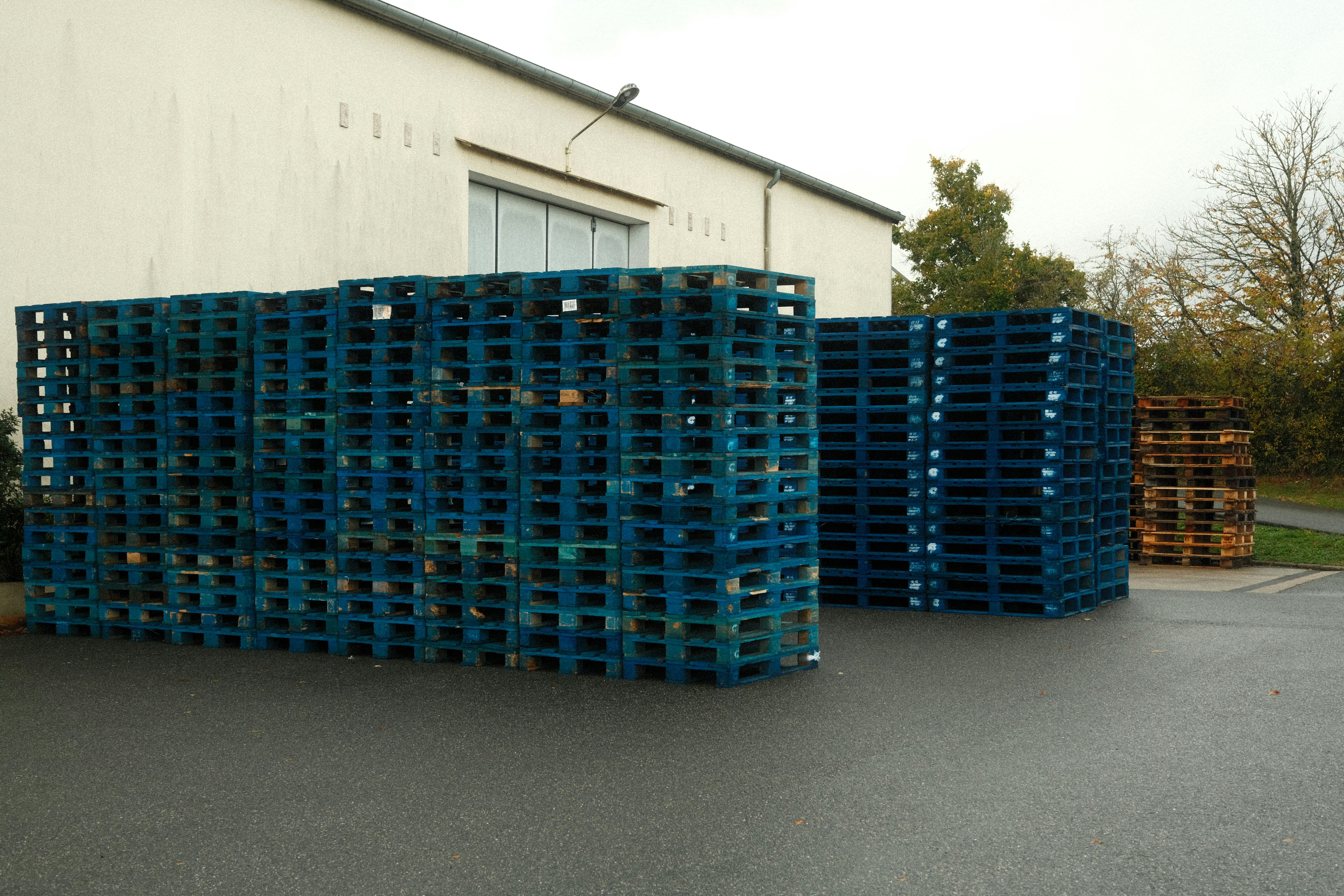 Stacked new plastic pallets in a warehouse