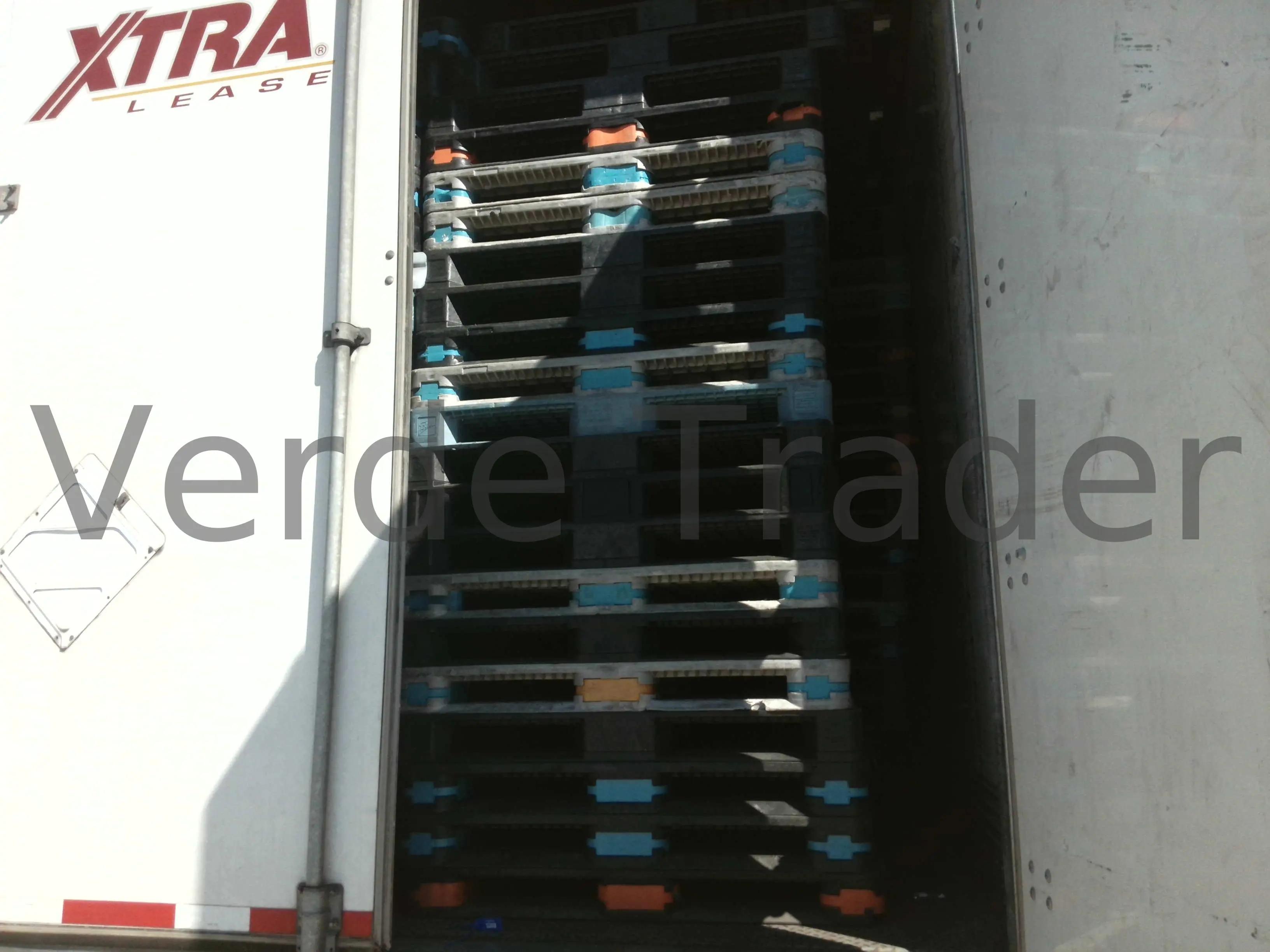 Palletized cargo loaded into a shipping container doorway