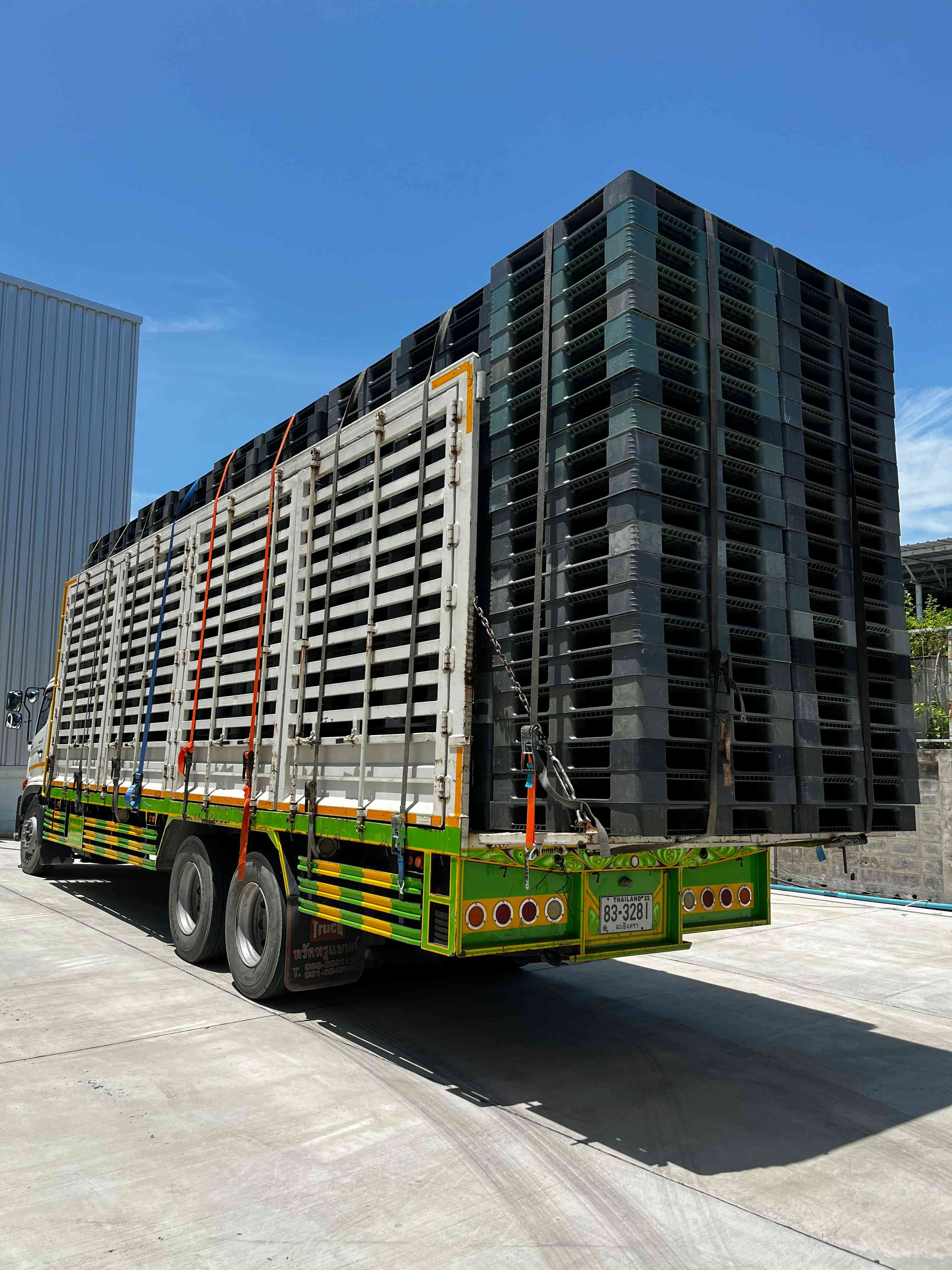 Nestable plastic pallets stacked inside a shipping container