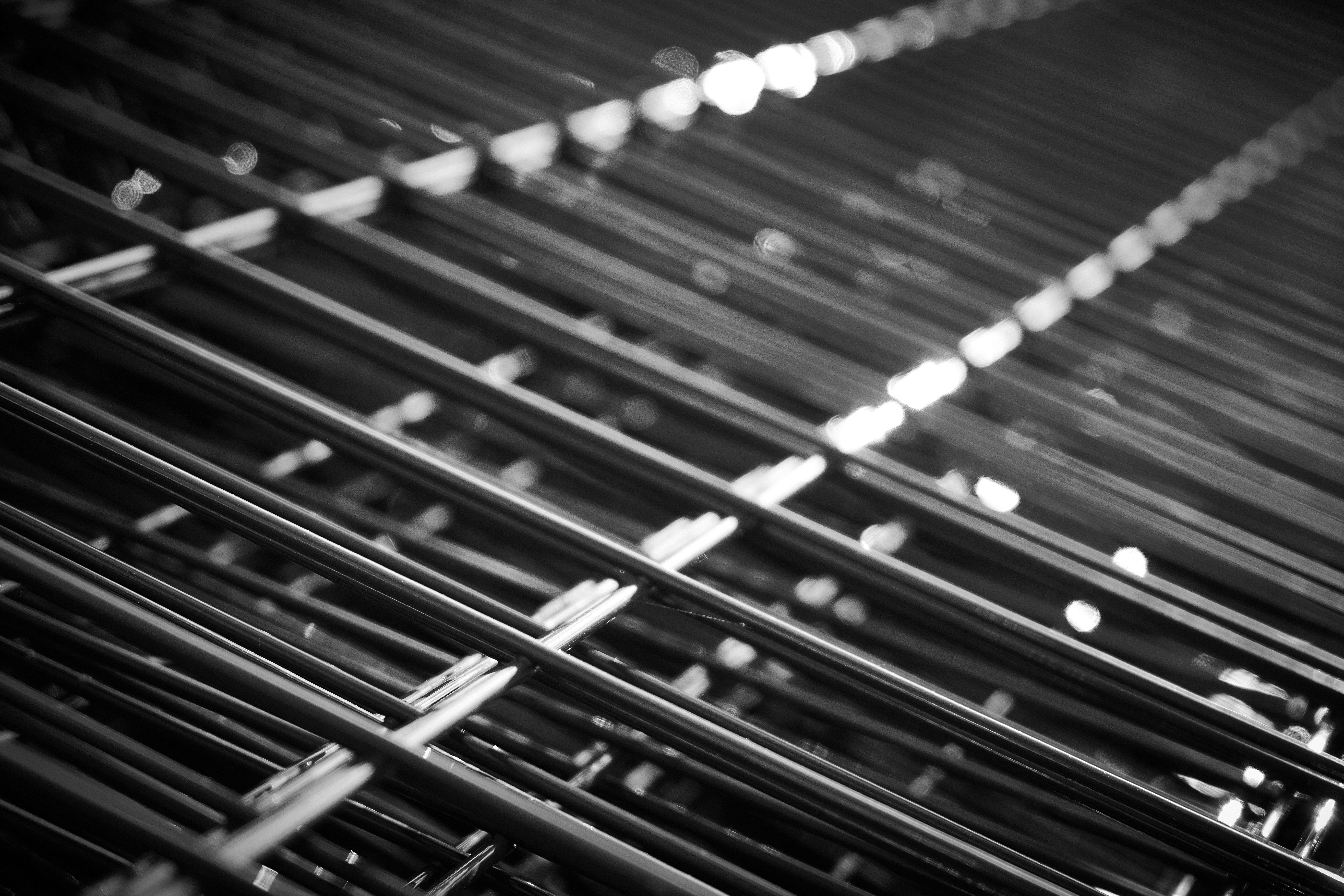 Underside of a rackable plastic pallet showing steel reinforcement rods embedded in the runners