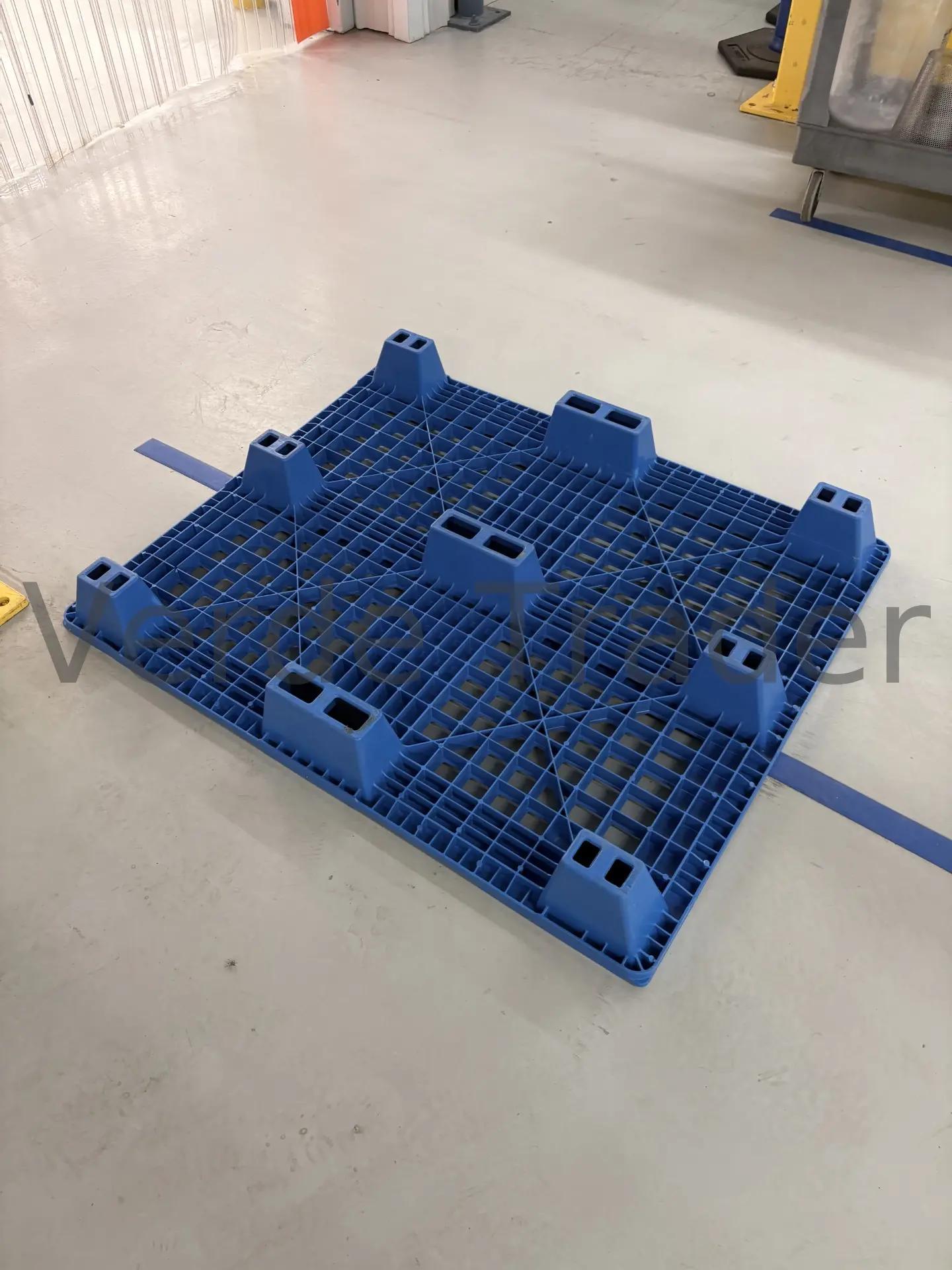 Nestable plastic pallets stacked inside each other in a tight column