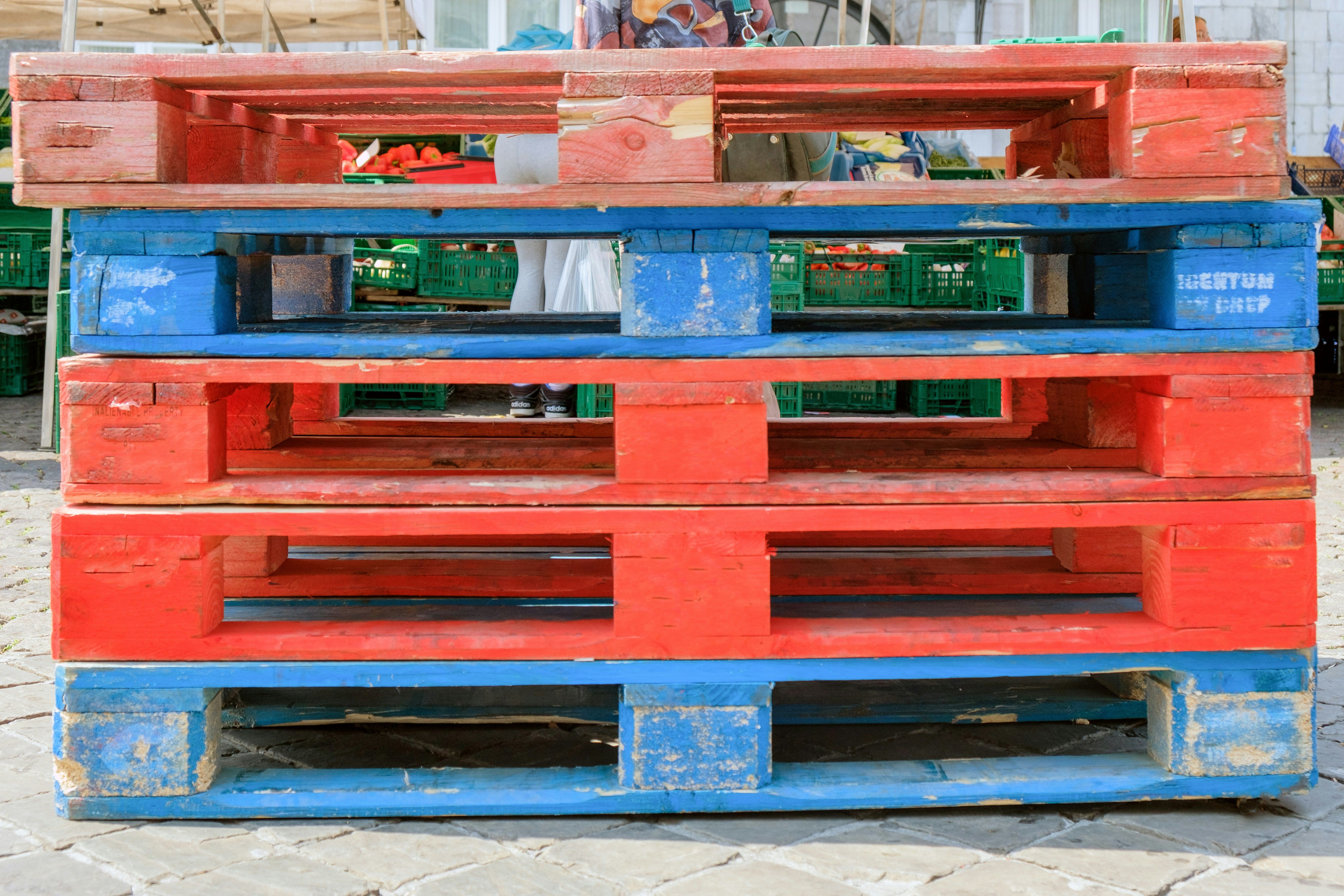 Single plastic pallet showing top deck and structural underside on a warehouse floor