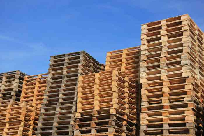A photo of stacks of block wood pallets