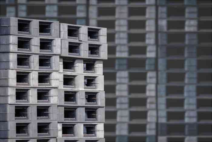 A Photo of Stacks of Black Plastic Pallets