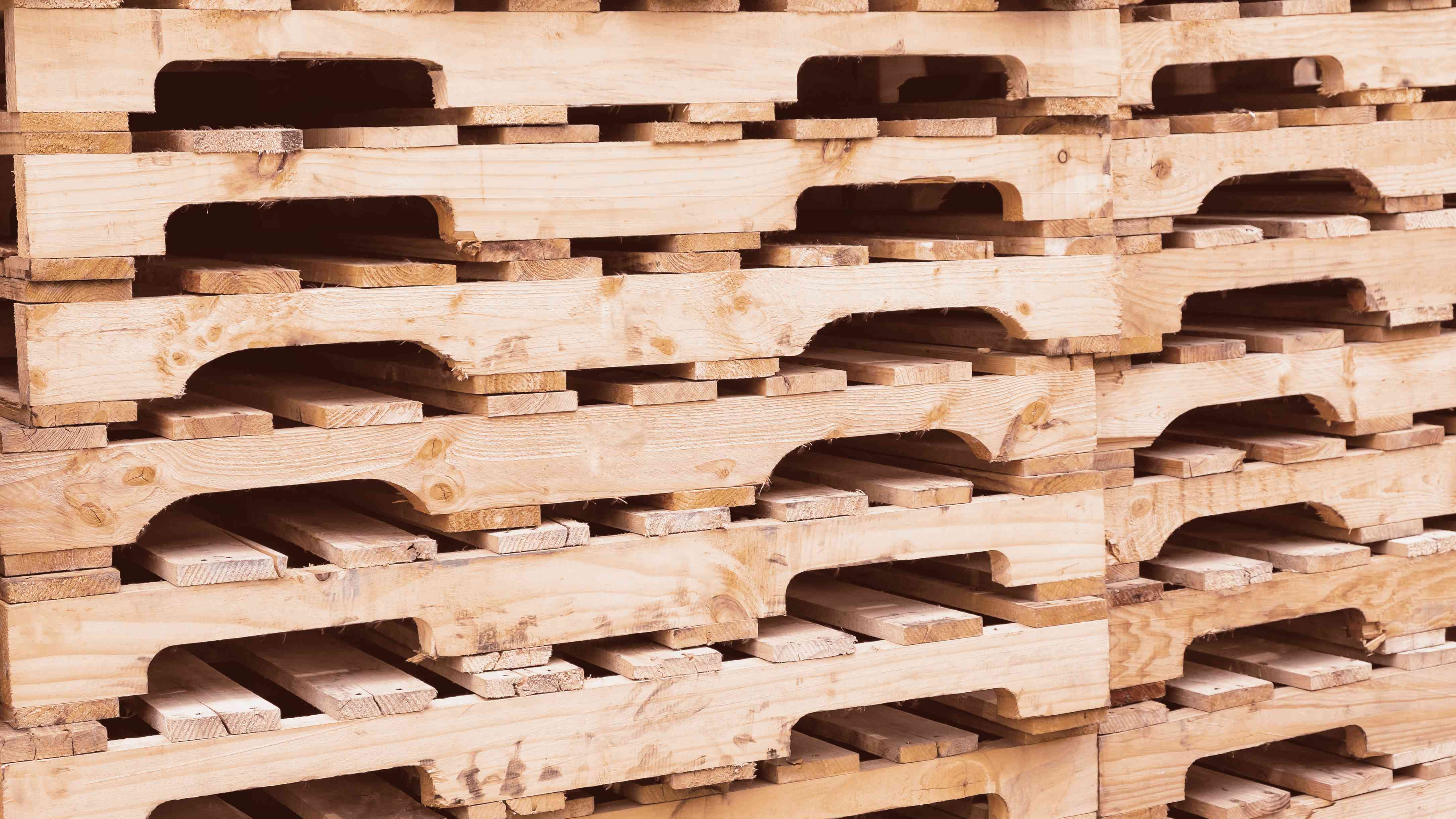 A photo of stacked 4-way wood pallets