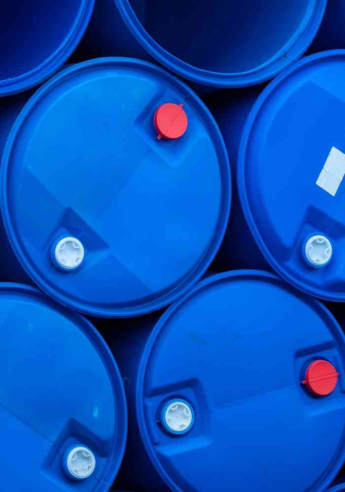 Photo of plastic drums stacked on their sides