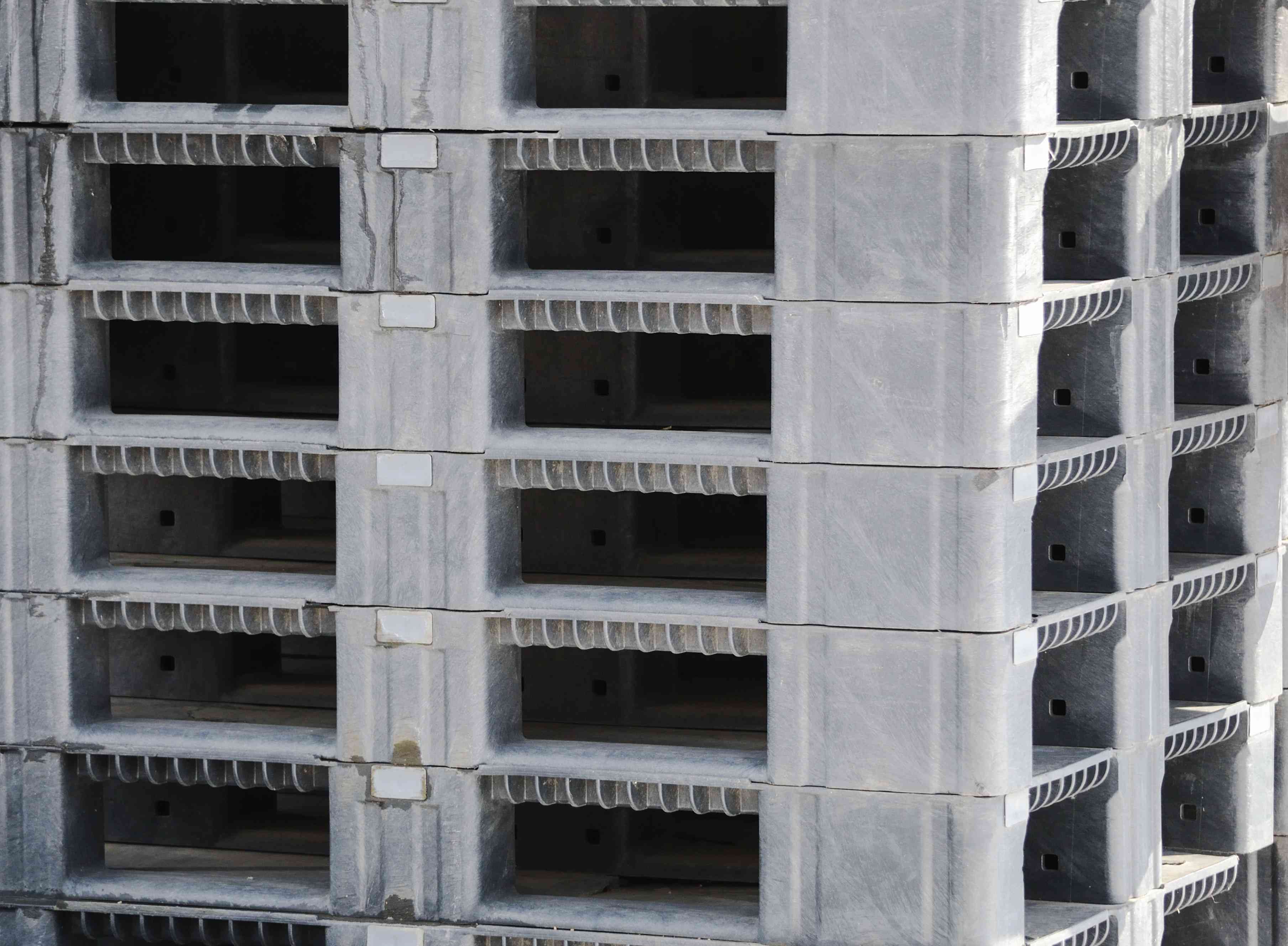 Photo of a stack of stackable plastic pallets