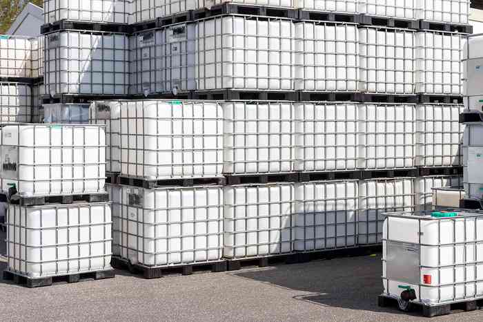 ibc totes stacked on pavement