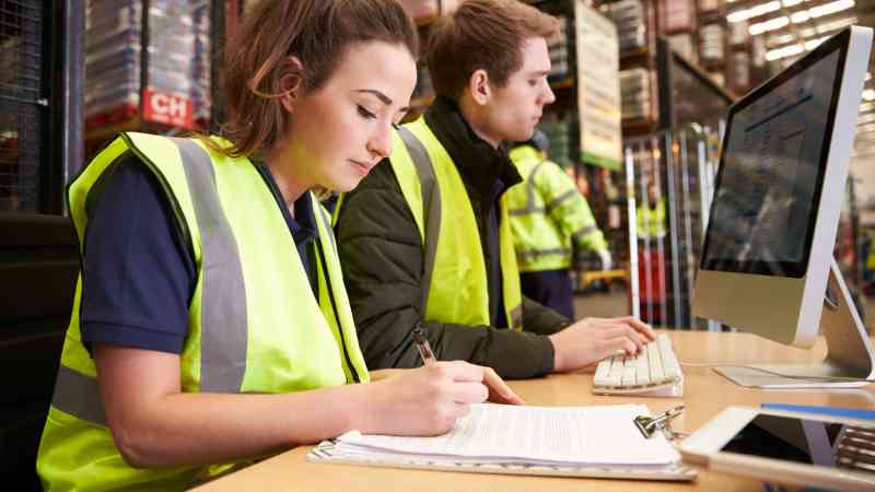 woman and man at a desk in a warehouse